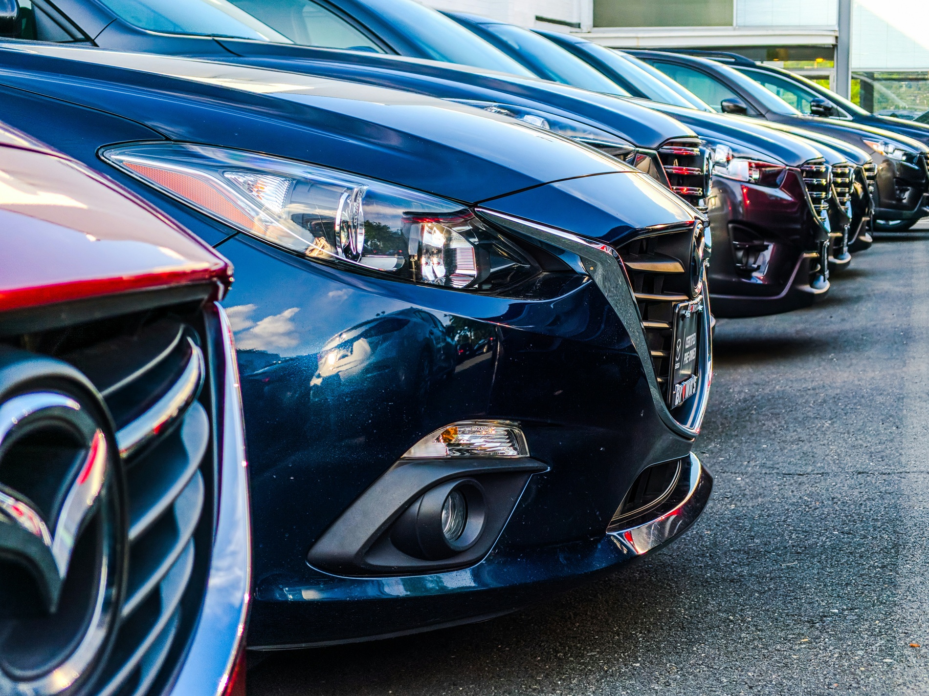 Photo of a Row of Rental Cars. Photo by Obi under license by Unsplash.com